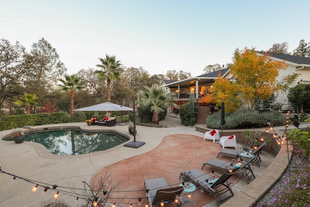 view of swimming pool featuring a patio area