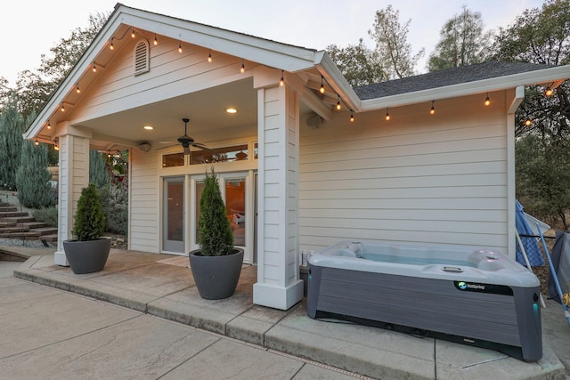 rear view of house featuring a patio area, ceiling fan, and a hot tub