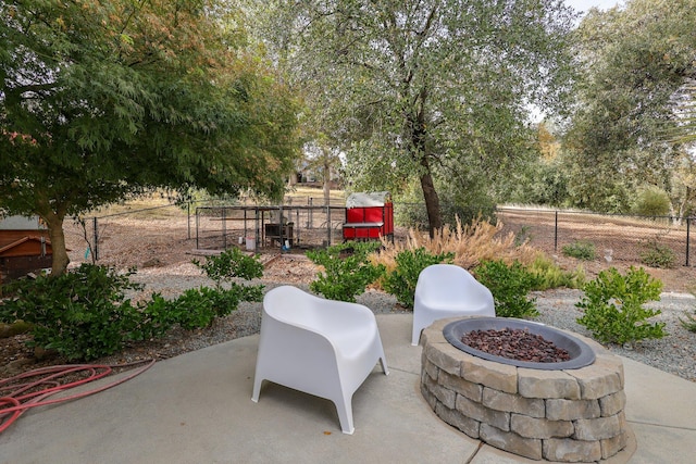 view of patio / terrace featuring an outdoor fire pit