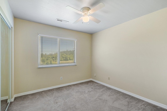 empty room with light carpet and ceiling fan