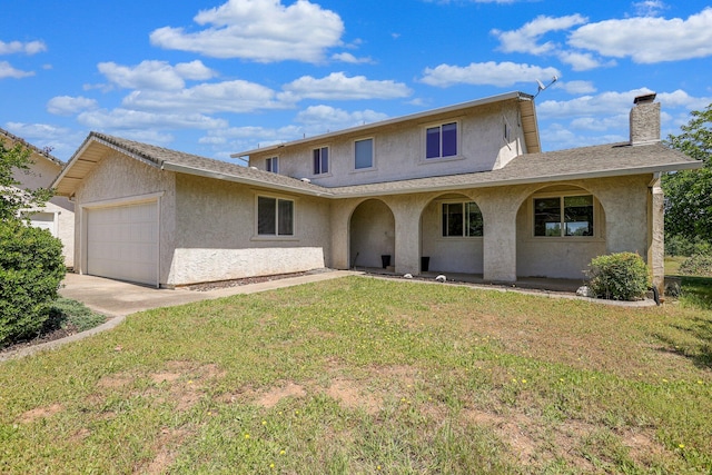 view of front property featuring a garage and a front lawn