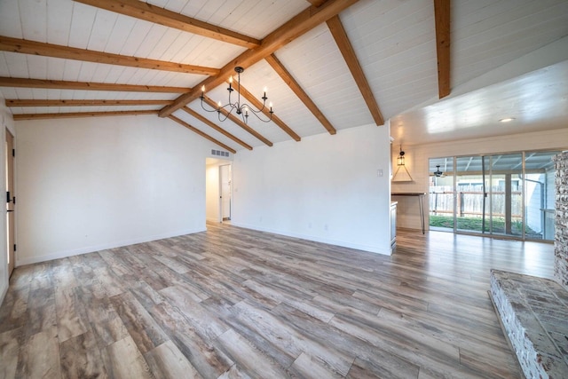 unfurnished living room featuring vaulted ceiling with beams, a notable chandelier, wood finished floors, visible vents, and baseboards