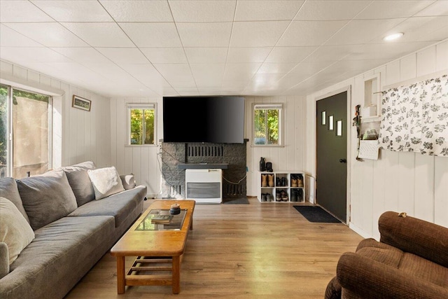 living room with wooden walls and hardwood / wood-style floors