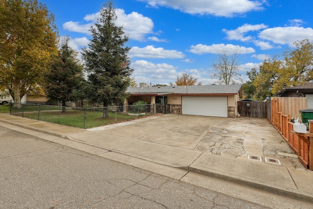 1535 Cordova St, Anderson, CA 96007 - view of front of home with concrete driveway, a garage, stone siding, and stucco siding