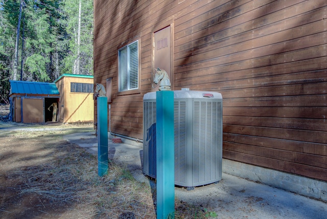 view of side of home with central AC unit