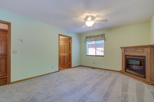 unfurnished living room with ceiling fan and light carpet