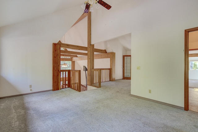 interior space featuring high vaulted ceiling, ceiling fan, light colored carpet, and a wealth of natural light