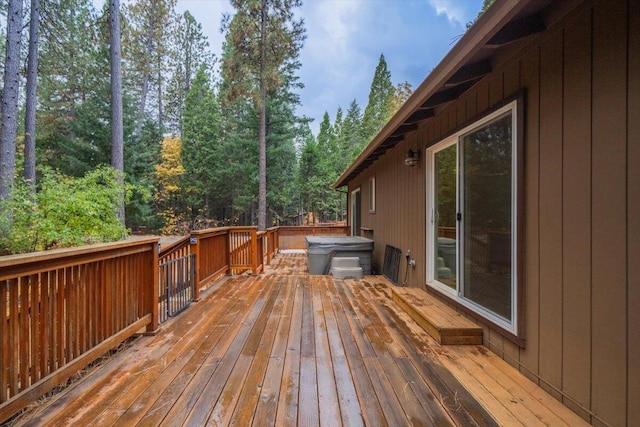 wooden terrace featuring a hot tub