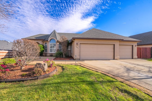 ranch-style house featuring a front yard and a garage