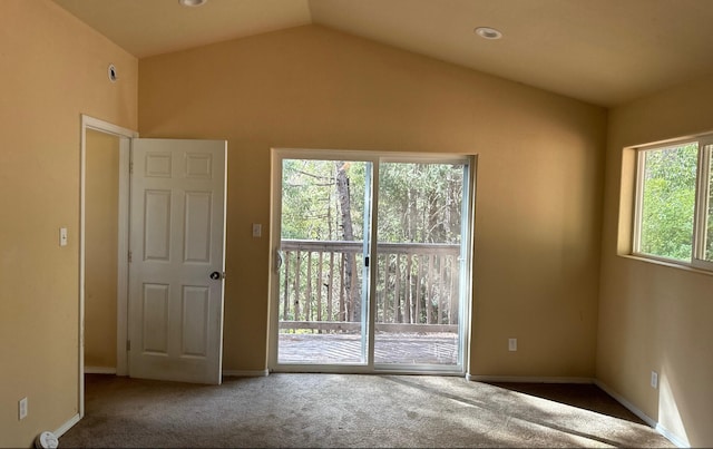 empty room featuring carpet and lofted ceiling