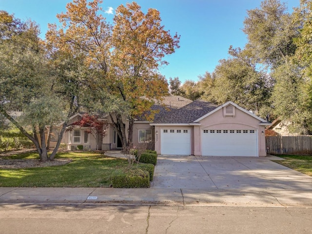 view of front of home featuring a garage and a front lawn