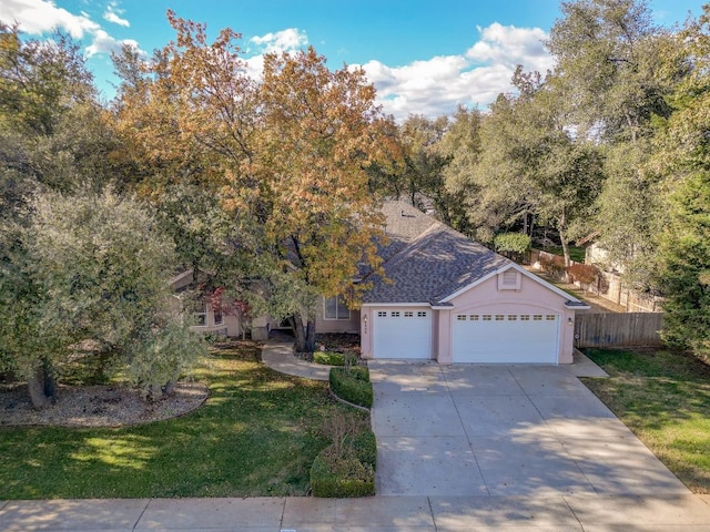 view of front of property with a front yard and a garage