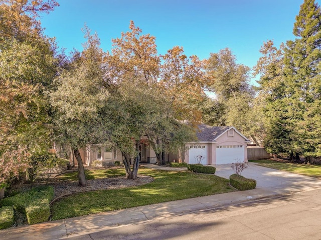 view of front of home with a front yard and a garage