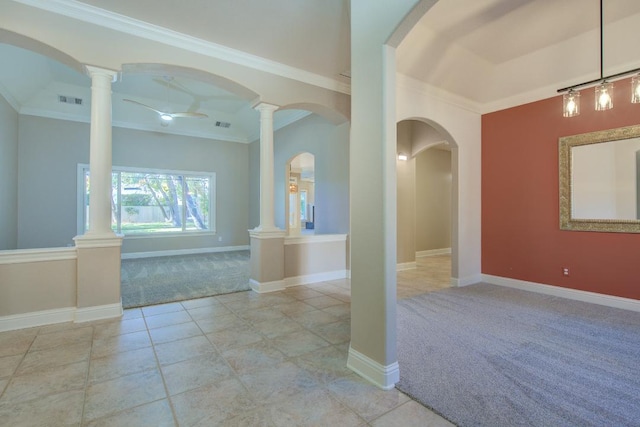 carpeted empty room with ornate columns and crown molding