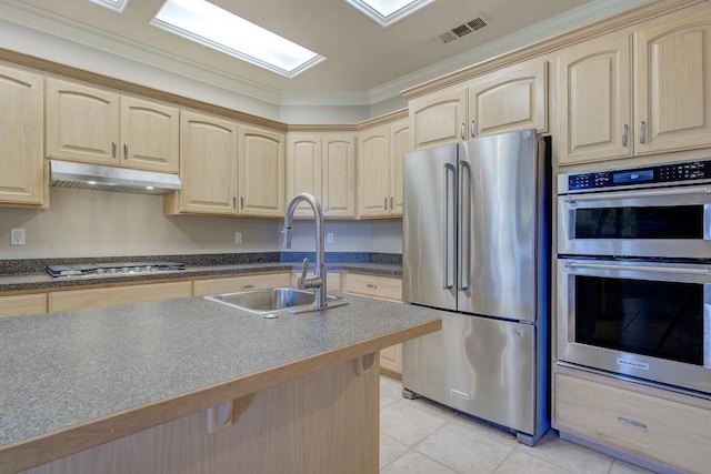 kitchen featuring sink, light tile patterned floors, ornamental molding, light brown cabinetry, and appliances with stainless steel finishes