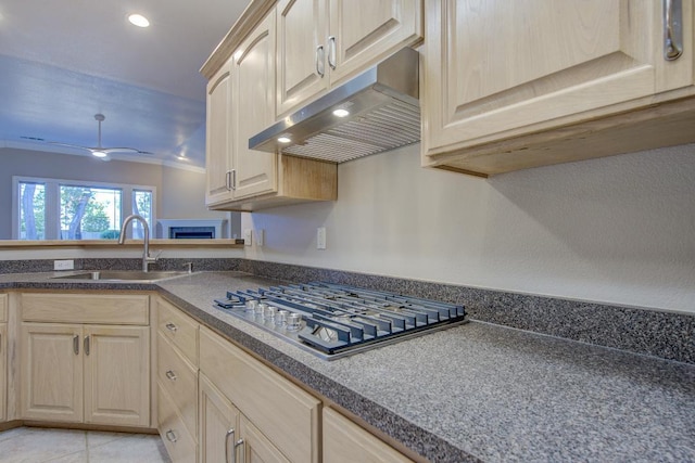 kitchen with stainless steel gas stovetop, sink, light tile patterned floors, and light brown cabinets