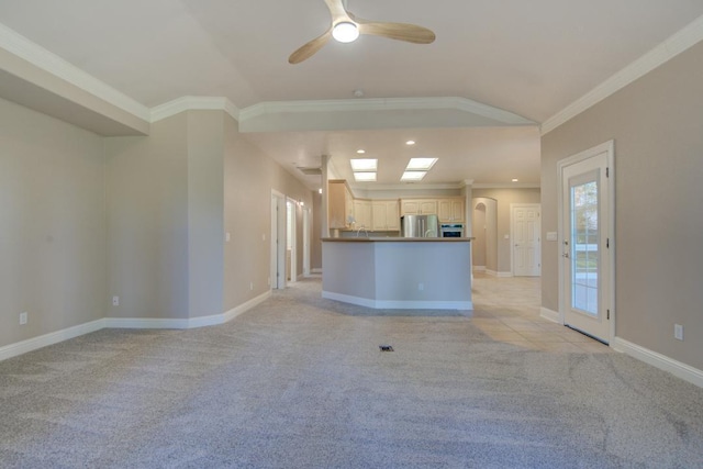 unfurnished living room featuring light carpet, lofted ceiling, and ornamental molding