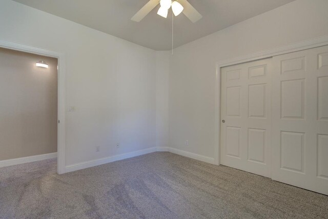 unfurnished bedroom featuring carpet, a closet, and ceiling fan