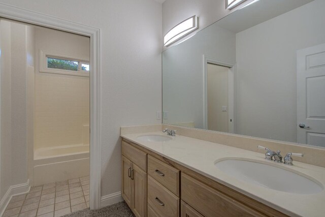 bathroom with tile patterned floors, shower / washtub combination, and vanity