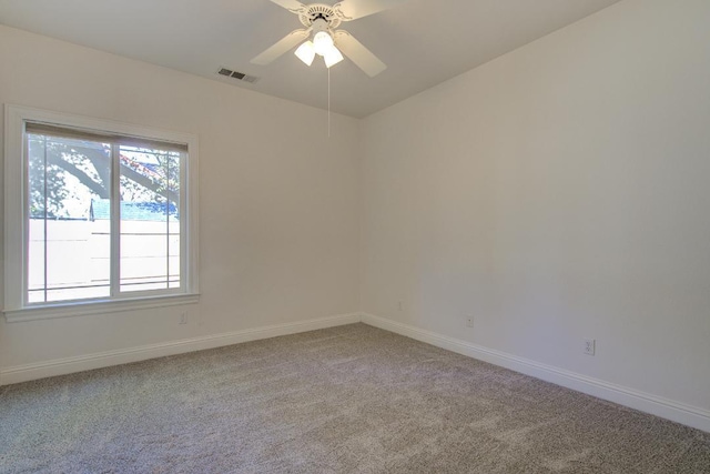 carpeted spare room featuring ceiling fan