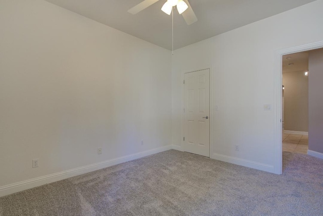 carpeted empty room with ceiling fan