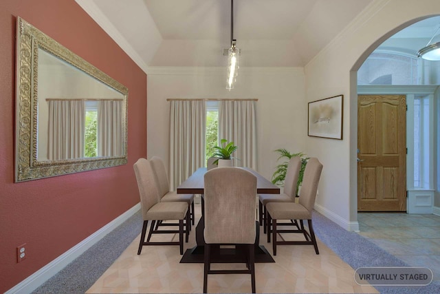 dining area featuring a tray ceiling, a wealth of natural light, and ornamental molding