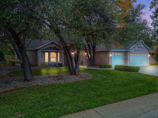 view of front facade with a lawn and a garage