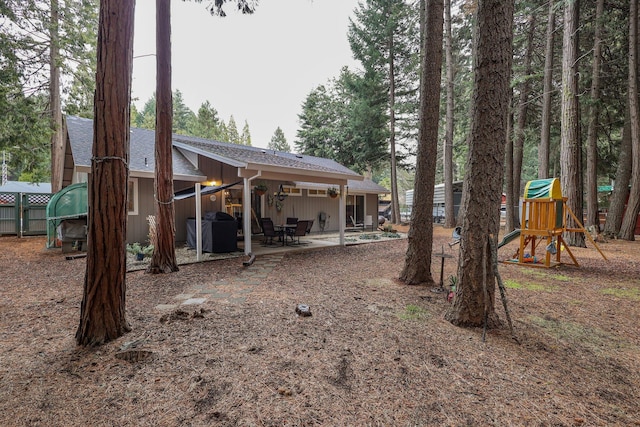 exterior space featuring a playground and a patio area