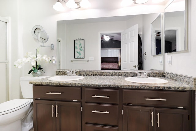 bathroom featuring ceiling fan, vanity, and toilet