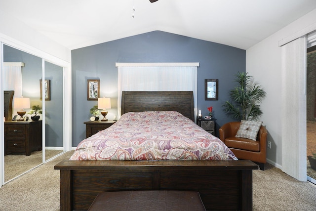 bedroom featuring ceiling fan, lofted ceiling, light carpet, and a closet