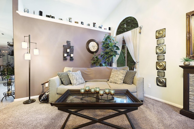 carpeted living room with high vaulted ceiling