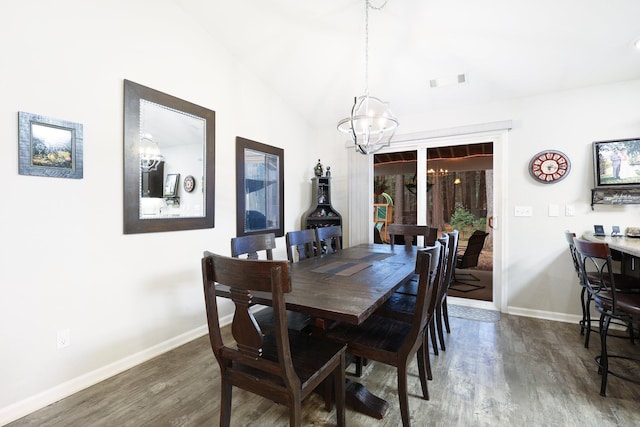 dining space with a chandelier, dark hardwood / wood-style flooring, and lofted ceiling