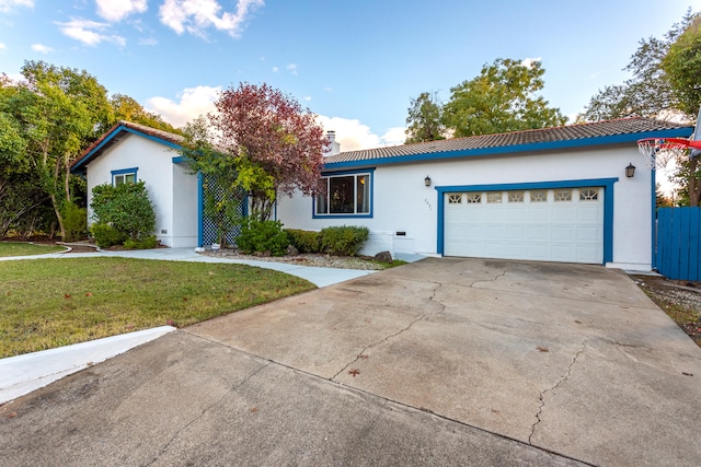 view of front of property with a garage and a front lawn