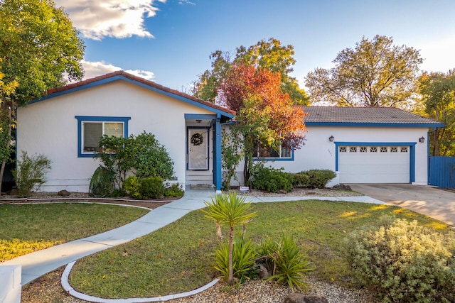 view of front of property featuring a front lawn and a garage