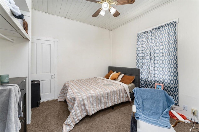 carpeted bedroom featuring ceiling fan and wood ceiling