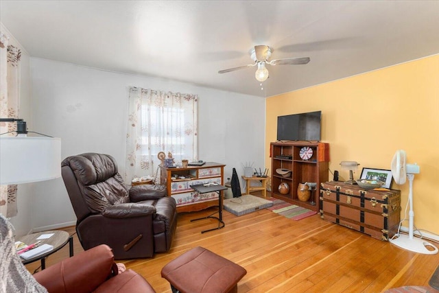 living room with ceiling fan and hardwood / wood-style flooring