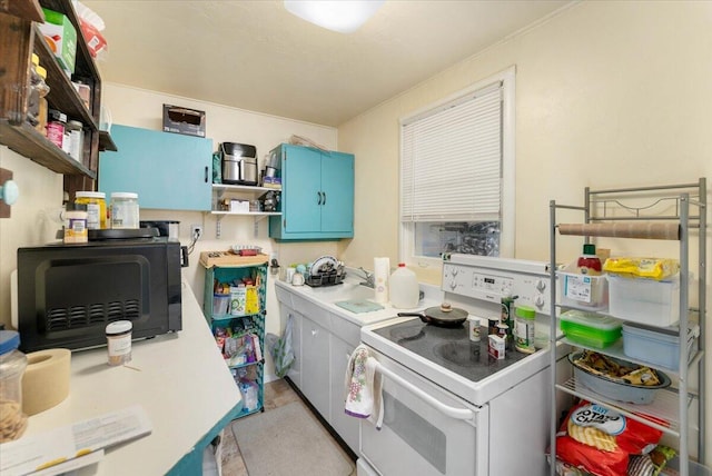 kitchen with electric range and blue cabinets