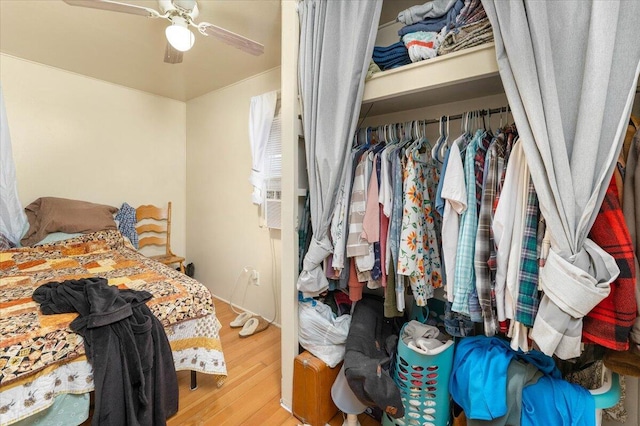 bedroom featuring ceiling fan, a closet, and hardwood / wood-style flooring