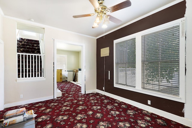 foyer featuring ceiling fan and ornamental molding