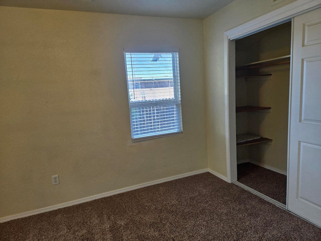 unfurnished bedroom featuring a closet and carpet floors