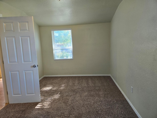 carpeted spare room with a textured ceiling