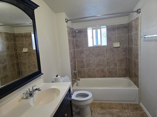 full bathroom featuring tile patterned flooring, vanity, toilet, and tiled shower / bath