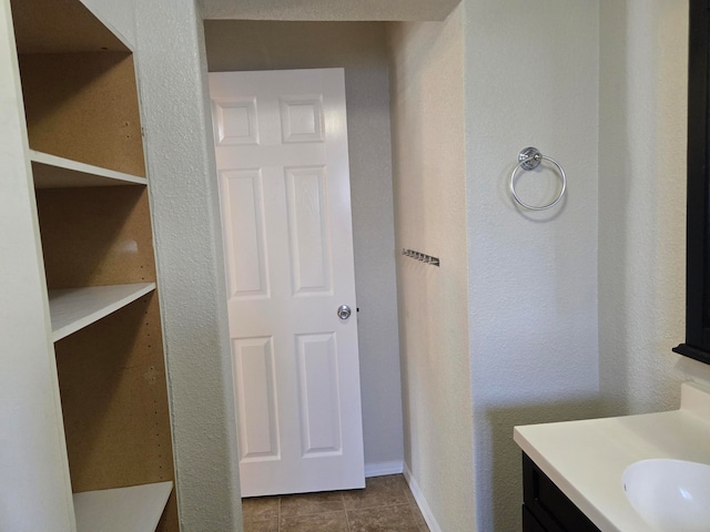 bathroom with tile patterned floors and vanity