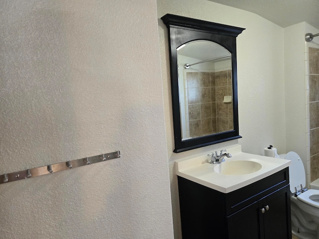 full bathroom with vanity, toilet, and tiled shower / bath combo