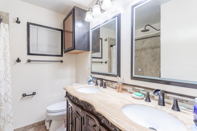 bathroom featuring curtained shower, vanity, and toilet