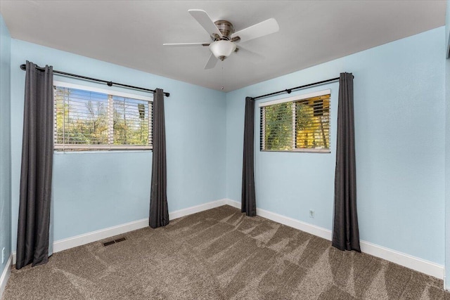 spare room with carpet flooring, ceiling fan, and plenty of natural light