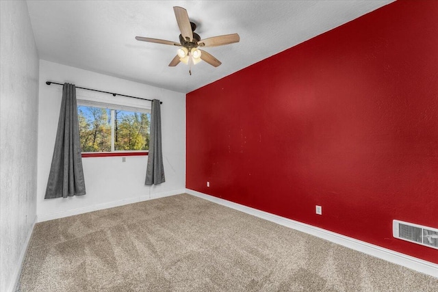 spare room featuring carpet and ceiling fan