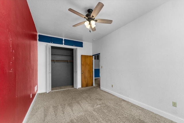 unfurnished bedroom with ceiling fan, a closet, and carpet