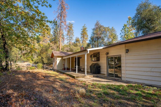 back of property with a patio