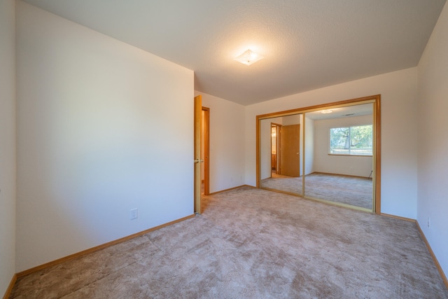 carpeted spare room with a textured ceiling